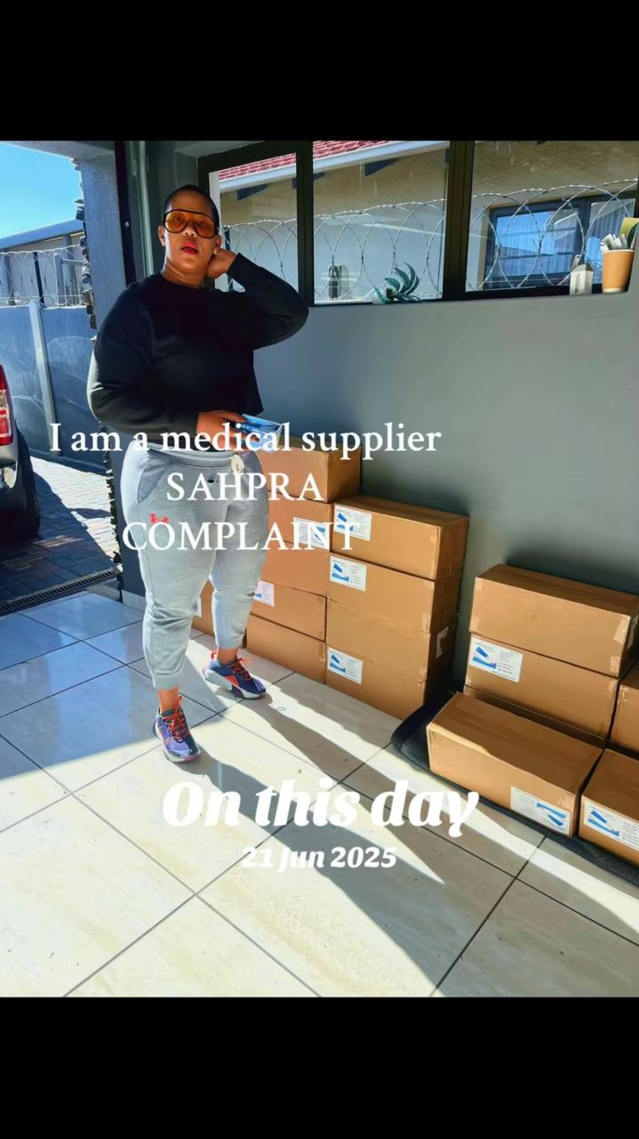Mphathi standing beside medical supply boxes